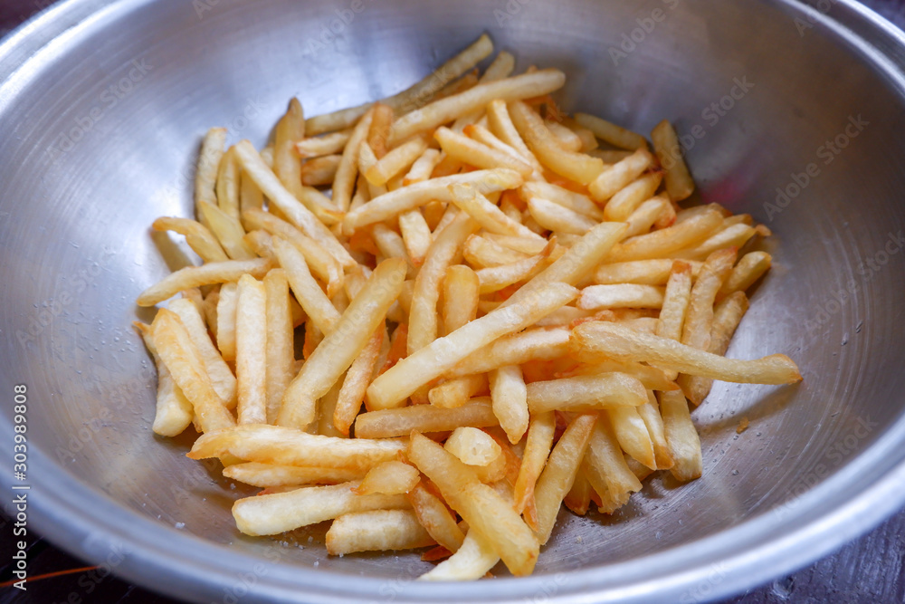 French fries in stainless bowl. French fries in stainless bowl.