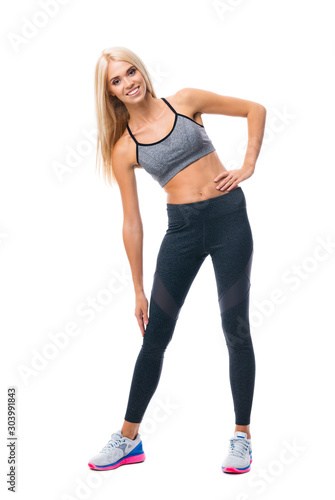 Full body portrait of young happy smiling blond beautiful girl, doing fitness exercise, isolated over white background © vgstudio