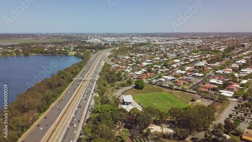 Aerial, busy freeway between residential suburb and lake, Perth, Australia photo