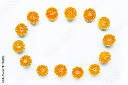 Frame made of fresh orange on white background.