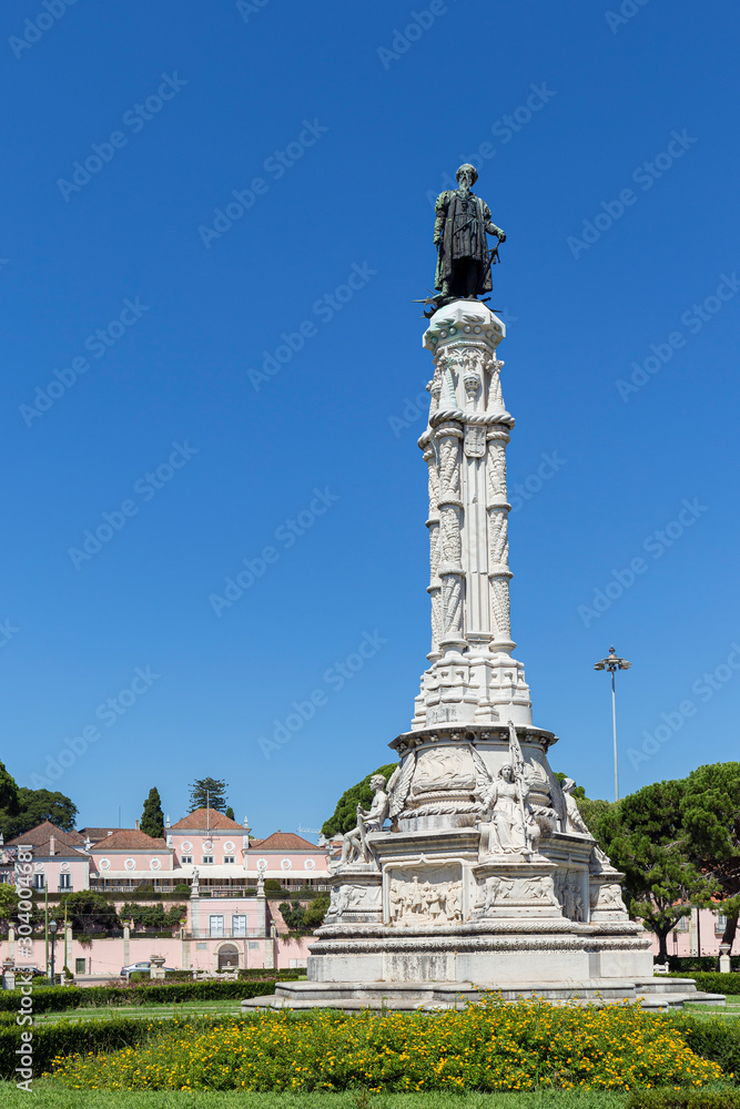 Belem Palace and Albuquerque monument at the Garden of Alfonso de Albuquerque in Belem district in Lisbon, Portugal, on a sunny day in the summer.