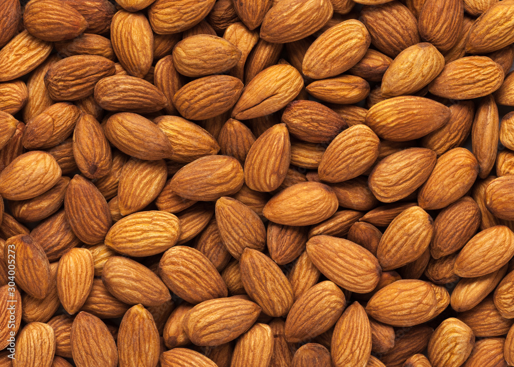 Almond background. Peeled almond kernels. Almond background. Peeled almond kernels.
