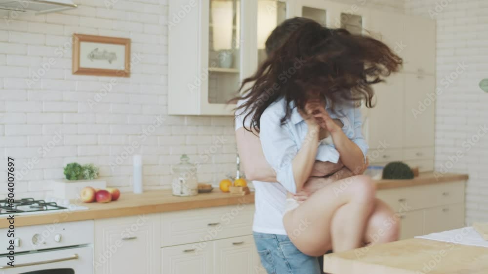 Young couple spinning around in house. Sexy man hugging woman in lingerie. Young couple spinning around in house. Sexy man hugging woman in lingerie.