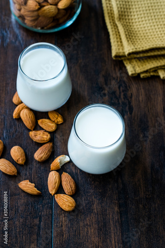 Almond Milk in Glass Cups with Almonds and Fabric Cloth.