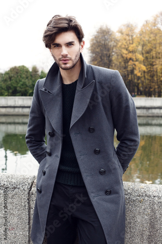 Handsome yong man in autumn coat. Outdoor fashion male portrait