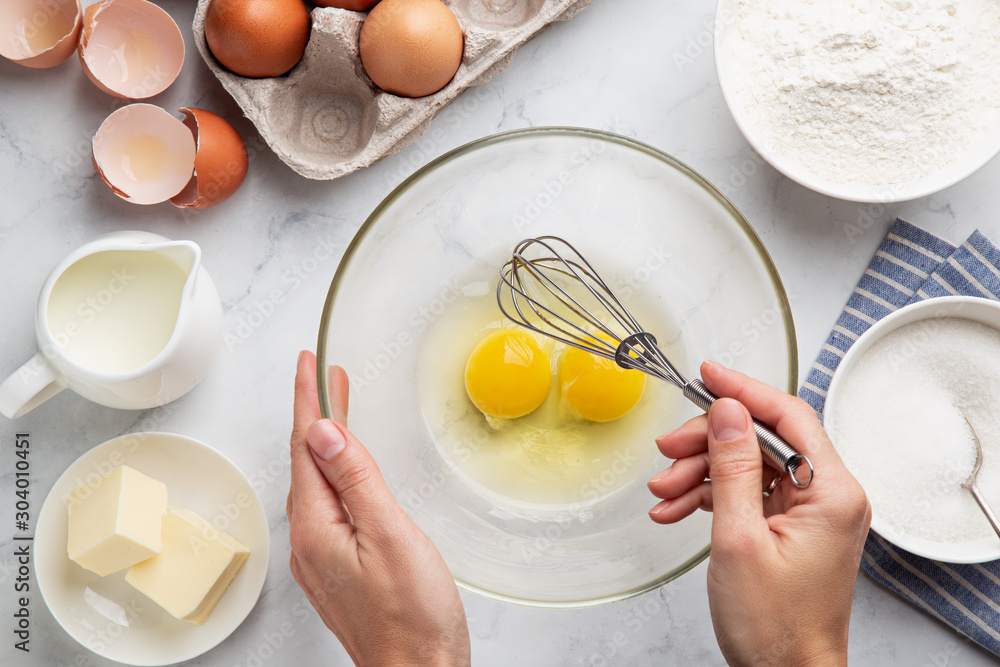 close up of female hands whisking eggs. Cooking cake - obrazy, fototapety, plakaty 