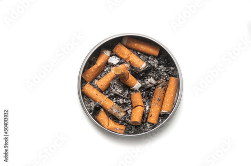 Top view of metallic ashtray full of cigarettes habits on white background