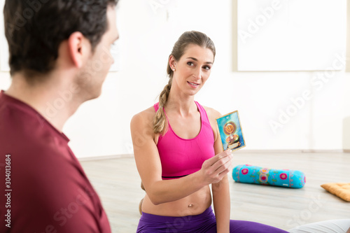 Woman showing card to man