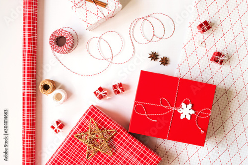 Christmas gift boxes with wrapping paper and decorations on white background. Festive concept.