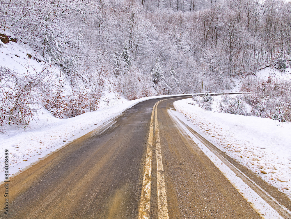 Empty asphalt road in snow covered spruce forest, beautiful winter landscape. Empty asphalt road in snow covered spruce forest, beautiful winter landscape.