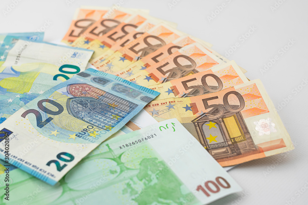 Close-up of fifty, twenty and one hundred euro bills on a table Close-up of fifty, twenty and one hundred euro bills on a table