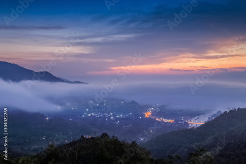 Mountain view misty morning above Kok river and Tha Ton city in valley around with sea of mist with cloudy sky background, sunrise at Wat Tha Ton, Fang, Chiang Mai, northern of Thailand.