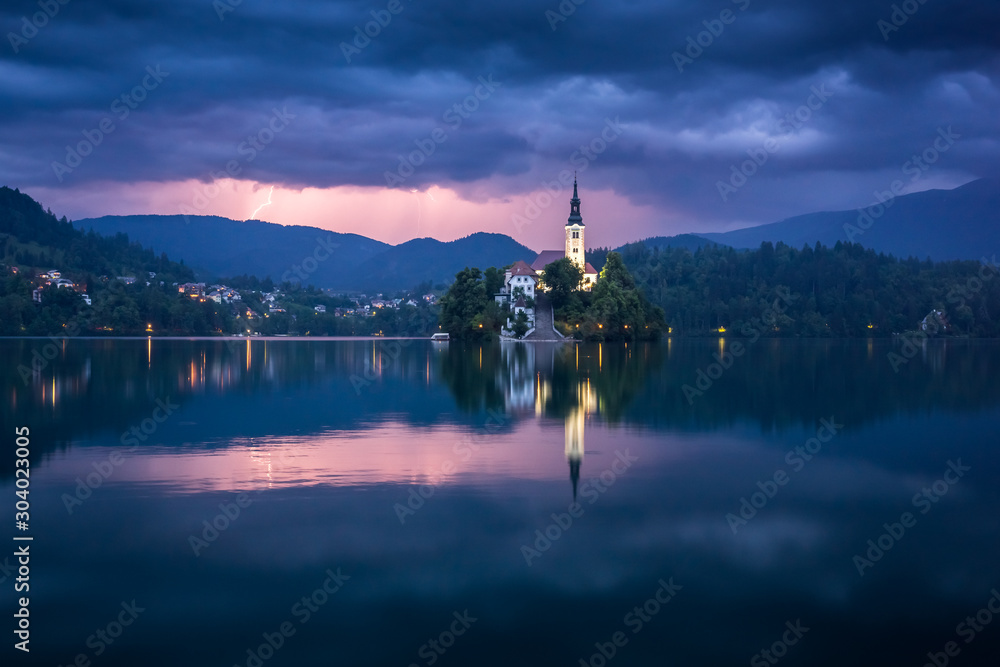 Storm clouds over a church on an island on Lake Bled, Slovenia