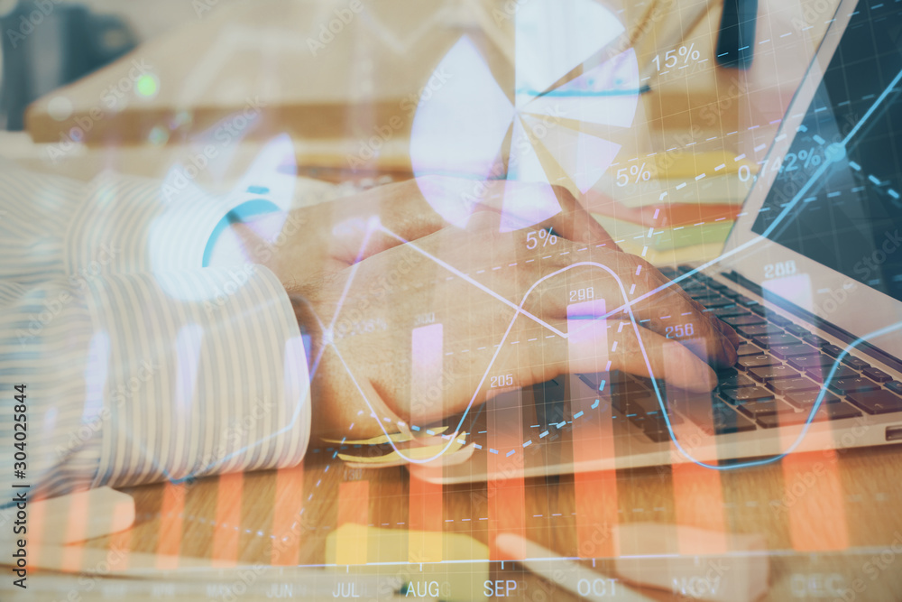 Multi exposure of stock market graph with man working on laptop on background. Concept of financial analysis. Multi exposure of stock market graph with man working on laptop on background. Concept of financial analysis.