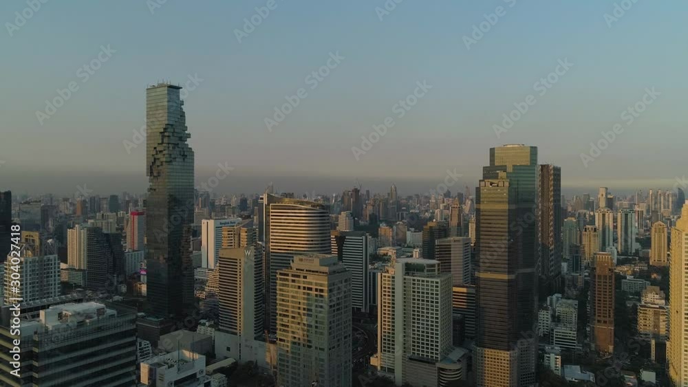 Bangkok endless skyline during golden hour, clear blue sky, aerial flyover Bangkok endless skyline during golden hour, clear blue sky, aerial flyover