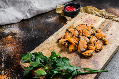 Fresh raw mussel meat on a wooden chopping Board. Healthy seafood