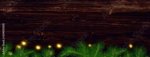 Christmas background for advertising or greetings. wooden background, spruce and glow.
