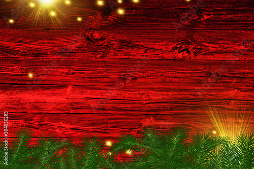 Christmas background tree and sparkle bokeh lights on red canvas background. Merry christmas card. Winter holiday theme. Happy New Year. Space for text