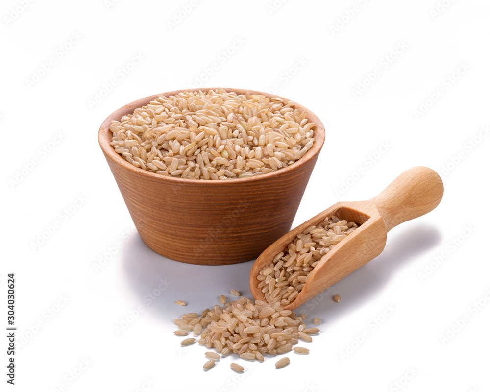 Unpolished wild brown rice rice in a wooden scoop and in a bowl isolated on white background Unpolished wild brown rice rice in a wooden scoop and in a bowl isolated on white background