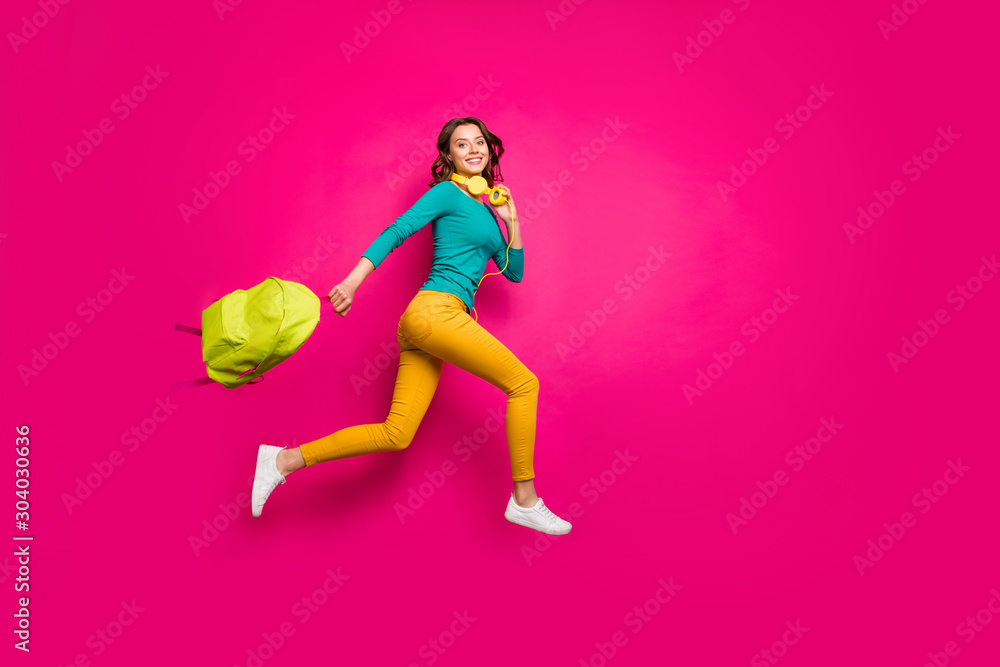Full length body size side profile photo of cheerful positive nice pretty cute youngster wearing yellow pants trousers smiling toothily isolated pink vibrant color background - obrazy, fototapety, plakaty 