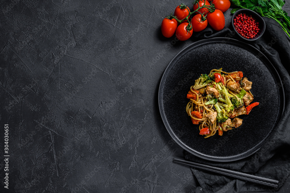 Stir fry noodles, traditional Chinese wok. chopsticks, ingredients. Space  for text. Asian noodles with vegetables, meat. Black dark background. Top  view Stock Photo | Adobe Stock
