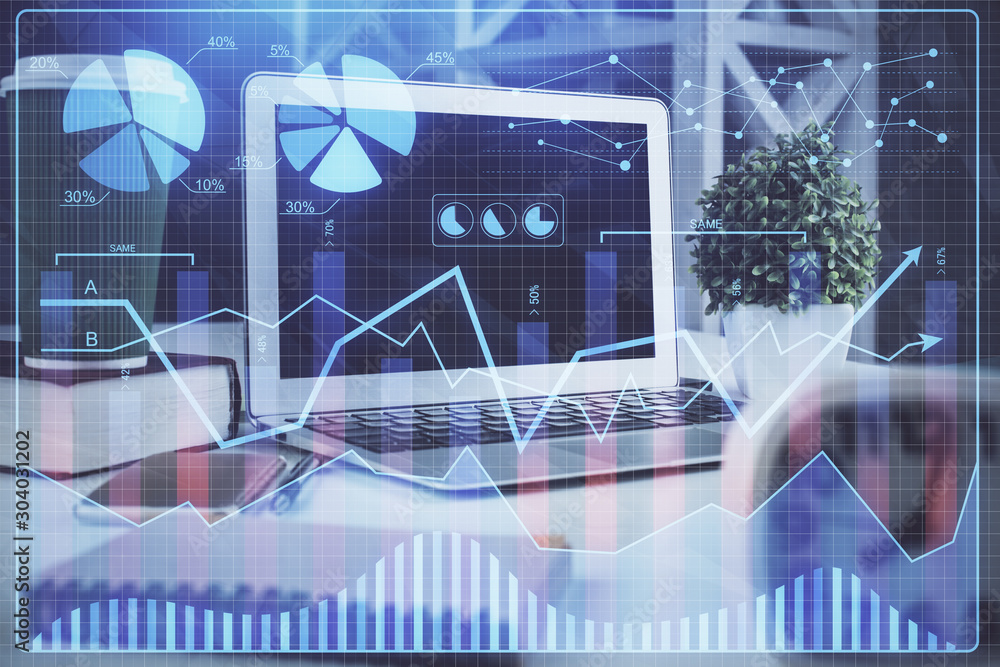 Financial market graph hologram and personal computer on background. Multi exposure. Concept of forex. Financial market graph hologram and personal computer on background. Multi exposure. Concept of forex.