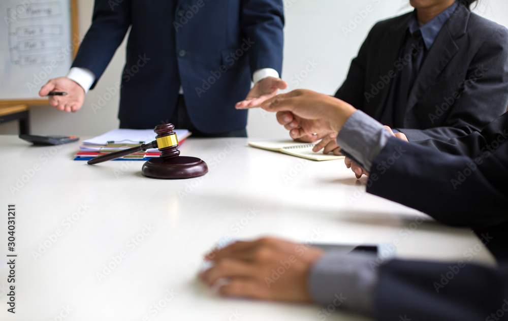 business people and lawyers discussing contract papers sitting at the table : and handshake after good cooper business people and lawyers discussing contract papers sitting at the table : and handshake after good cooper