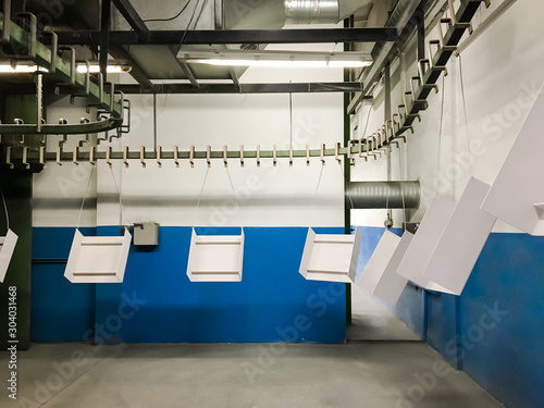 Powder coating of metal parts in factory