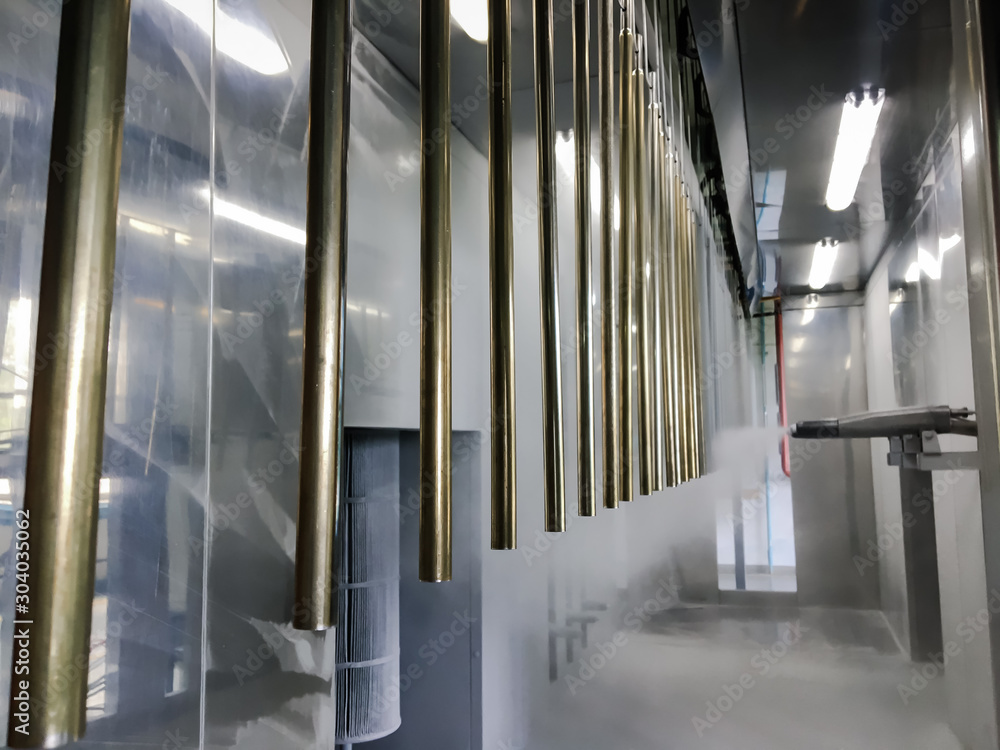 Obraz premium Industrial conveyor line at the factory for metal parts. Pretreatment of the surface of parts and paint parts with powder paint.