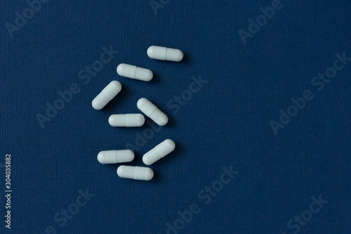 Capsules with medicine on a blue background