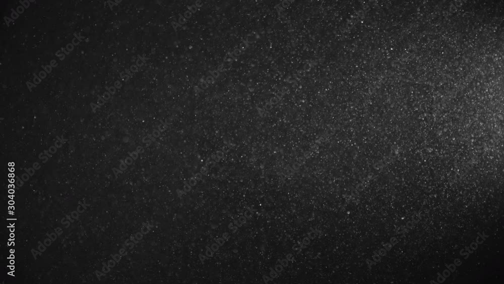 Natural Organic Dust Particles Floating On Black Background. Dynamic Dust Particles Randomly Float In Space With Fast And Slow Motion. Shimmering Glittering White Particles With Bokeh In The Air. Natural Organic Dust Particles Floating On Black Background. Dynamic Dust Particles Randomly Float In Space With Fast And Slow Motion. Shimmering Glittering White Particles With Bokeh In The Air.