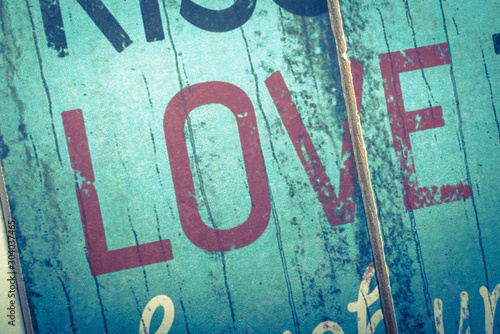 Love word printed on vintage wooden board. Calligraphy script love text.