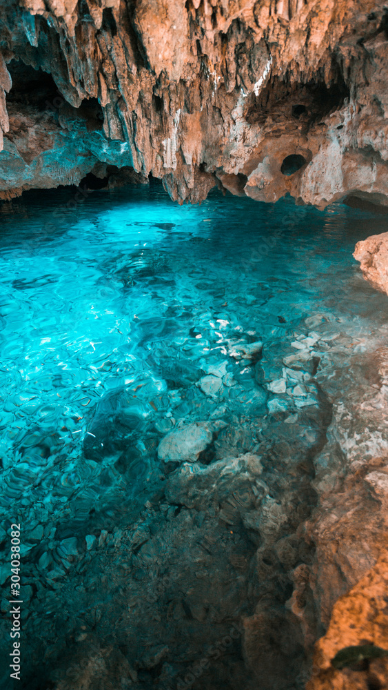 The crystal blue water in the rainbow cenote