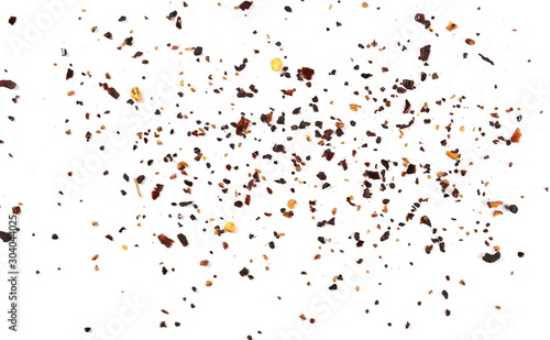 Dry red chili pepper flakes, cut up paprika pile isolated on white background, top view