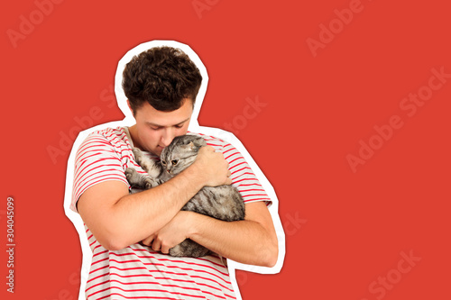 Canvastavla A cat and a man, a portrait of a happy cat with close eyes and a young man, people playing with a kitten