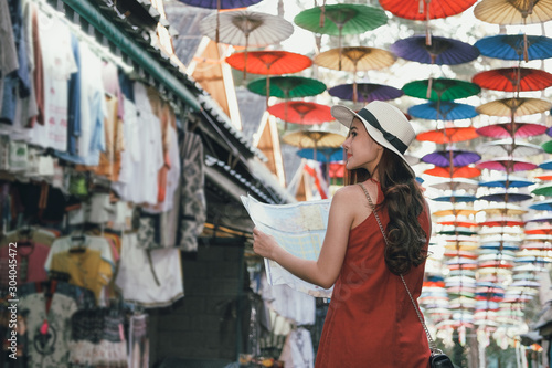 woman traveler tourist with map traveling on walking street. journey trip travel concept