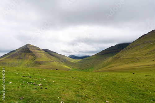 Eysturoy island landscape with green mountains covered with clouds. Faroe Islands, Denmark.