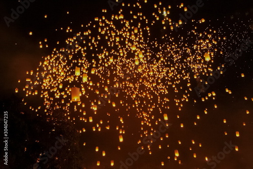 view of many sky lanterns in dark sky background, Lantern Festival in Chiang Mai, northern of Thailand.