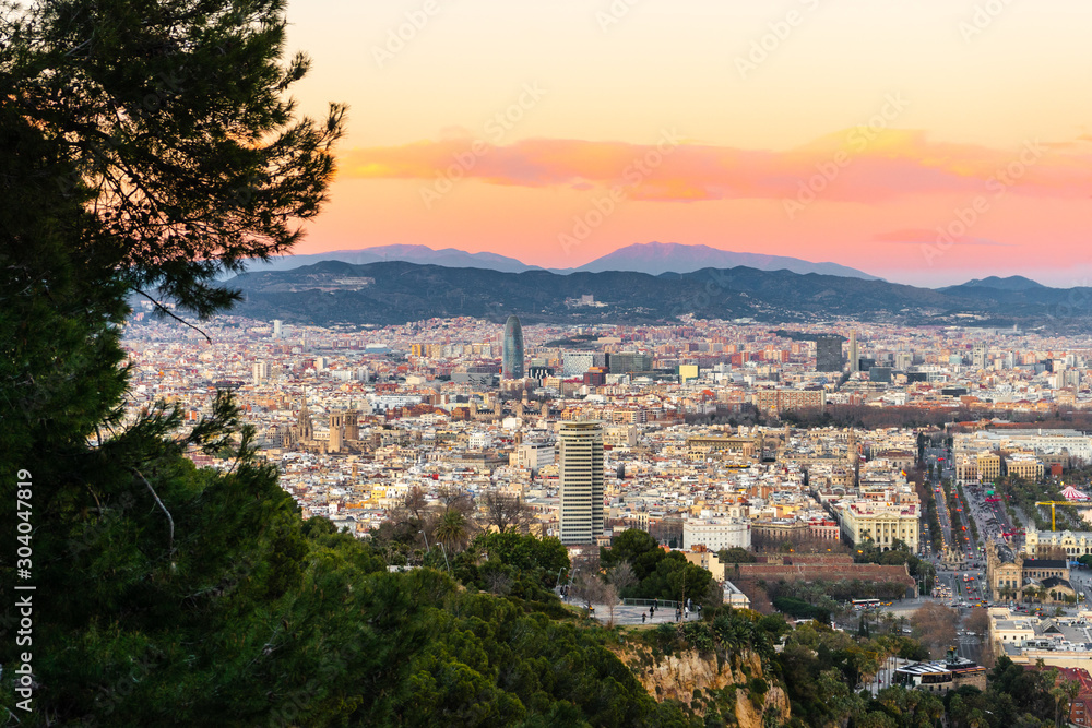 Cityscape of Barcelona. Buildings, roads, hills and sunset