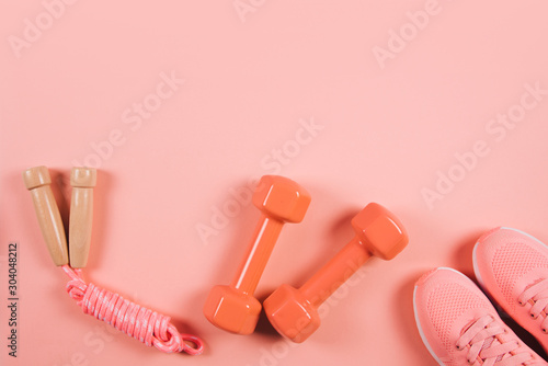 Creative flat lay of sport and fitness equipments on Living Coral background. © Olga