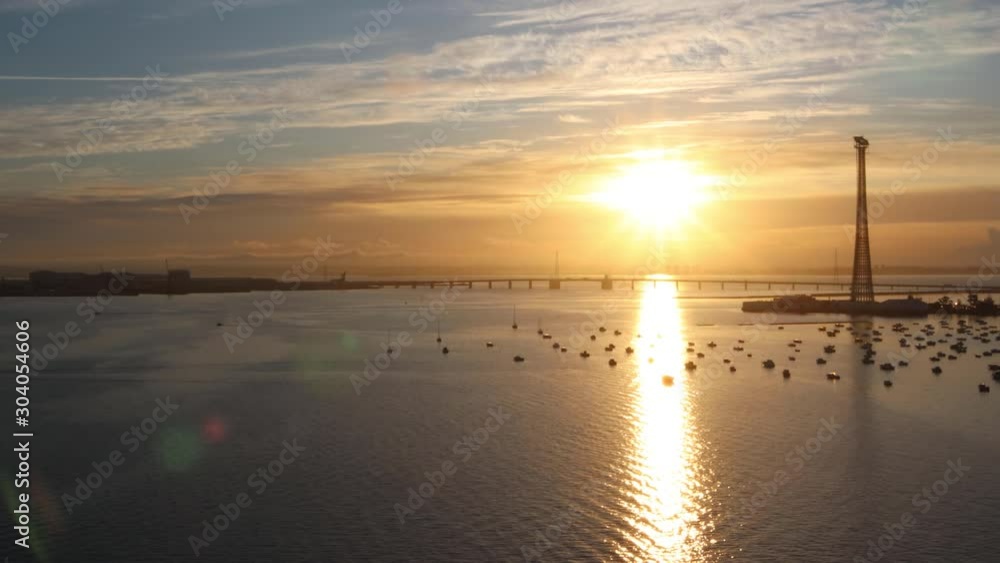 Background of sunrise in Cadiz. Real time 4K video. beautiful sunrise in Andalusia. A panoramic view with the orange and yellow reflexes on the sea and boats. Background of sunrise in Cadiz. Real time 4K video. beautiful sunrise in Andalusia. A panoramic view with the orange and yellow reflexes on the sea and boats.