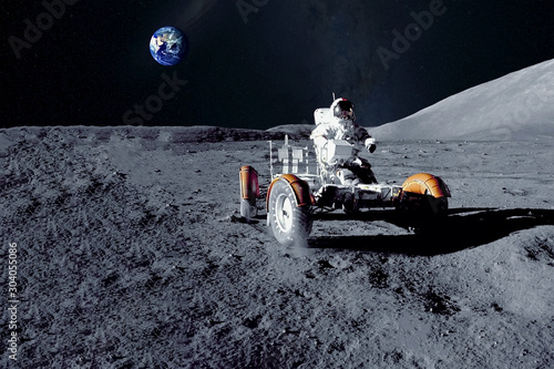 Astronaut near the moon rover on the moon. With land on the horizon. Elements of this image were furnished by NASA. photo