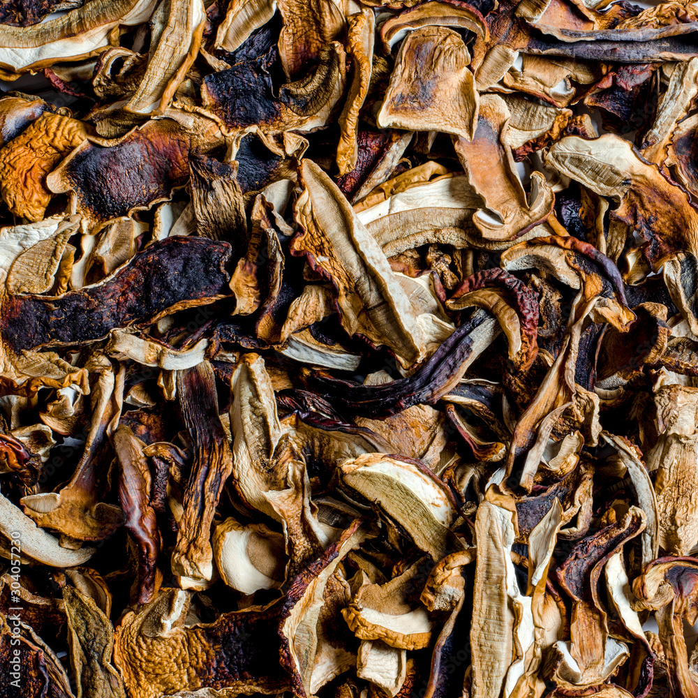 many dried mushrooms lies on a white wood desk many dried mushrooms lies on a white wood desk