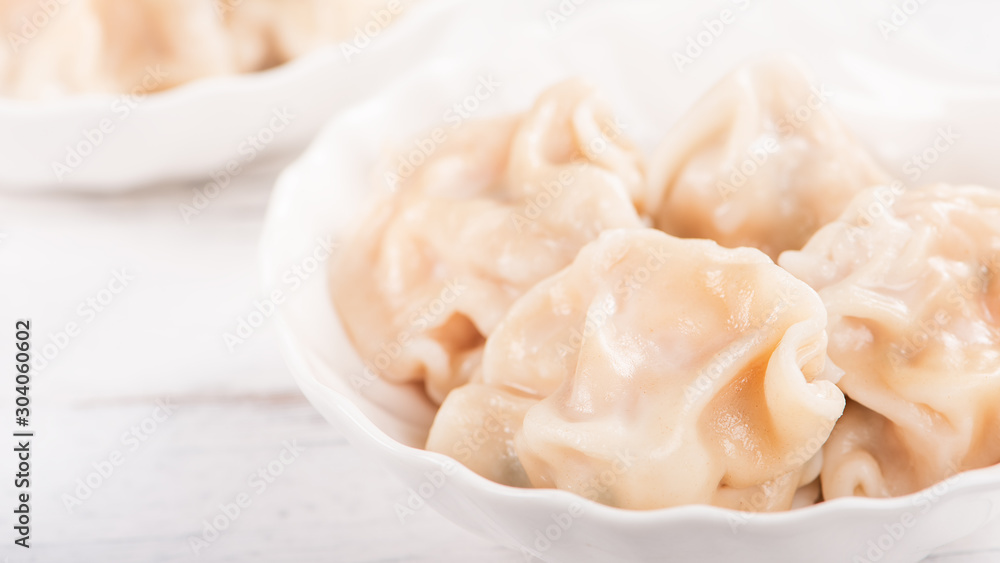 Fresh, delicious boiled pork, shrimp gyoza dumplings on white background with soy sauce and chopsticks, close up, lifestyle. Homemade design concept. Fresh, delicious boiled pork, shrimp gyoza dumplings on white background with soy sauce and chopsticks, close up, lifestyle. Homemade design concept.