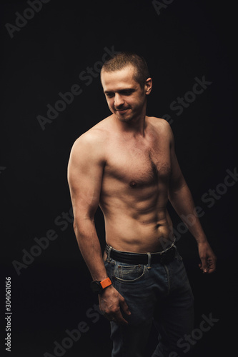 Shirtless man with natural real fit body standing in studio