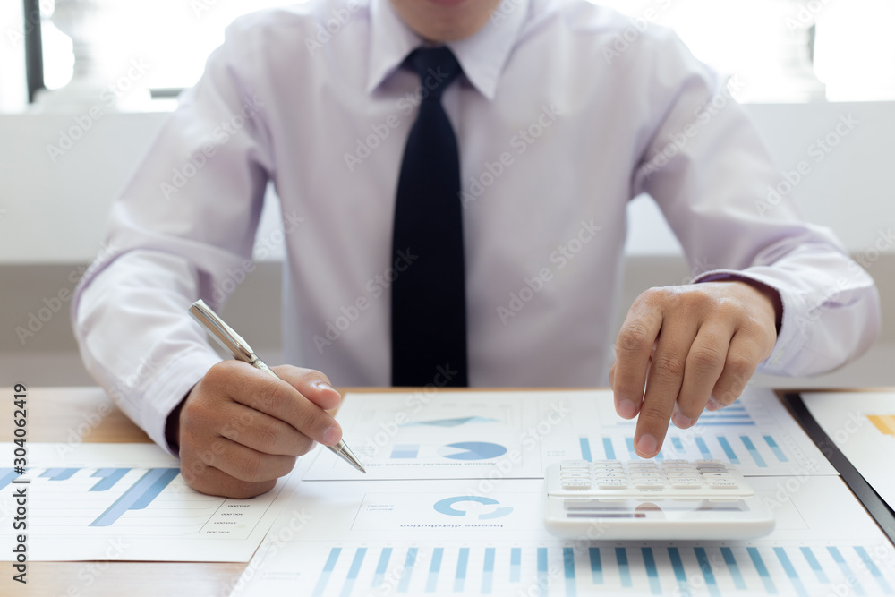 Calculate the calculator, Male employees work in private rooms Calculating company revenue figures with calculator, Financial accounting concepts Calculate the calculator, Male employees work in private rooms Calculating company revenue figures with calculator, Financial accounting concepts