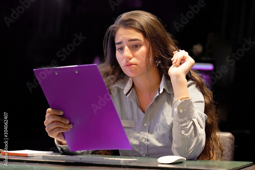 Woman mananger hotel worker reading negative news in report. photo