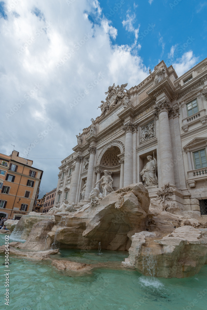 Rome, Italy - October 07, 2018: The Trevi Fountain standing 26 meters high and 20 meters wide, it is the largest Baroque fountain in the city. Fountain di Trevi surronded by hundreds of tourists