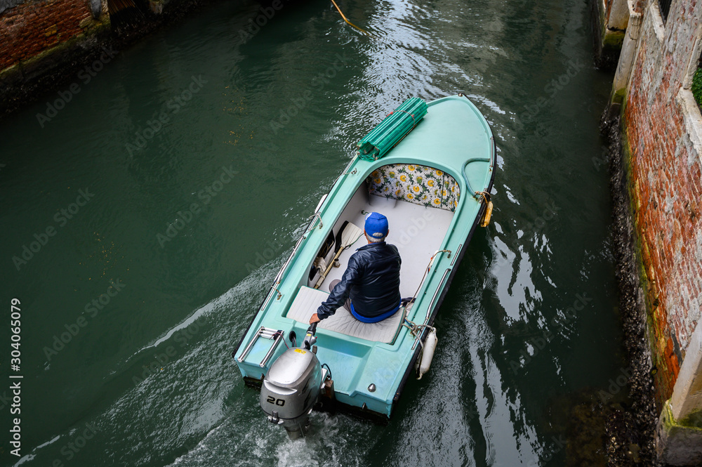 Venice, Italy, Motor boat in the turquoise channel