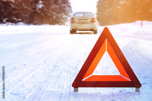 Red emergency stop sign broken silver car winter road forest sun